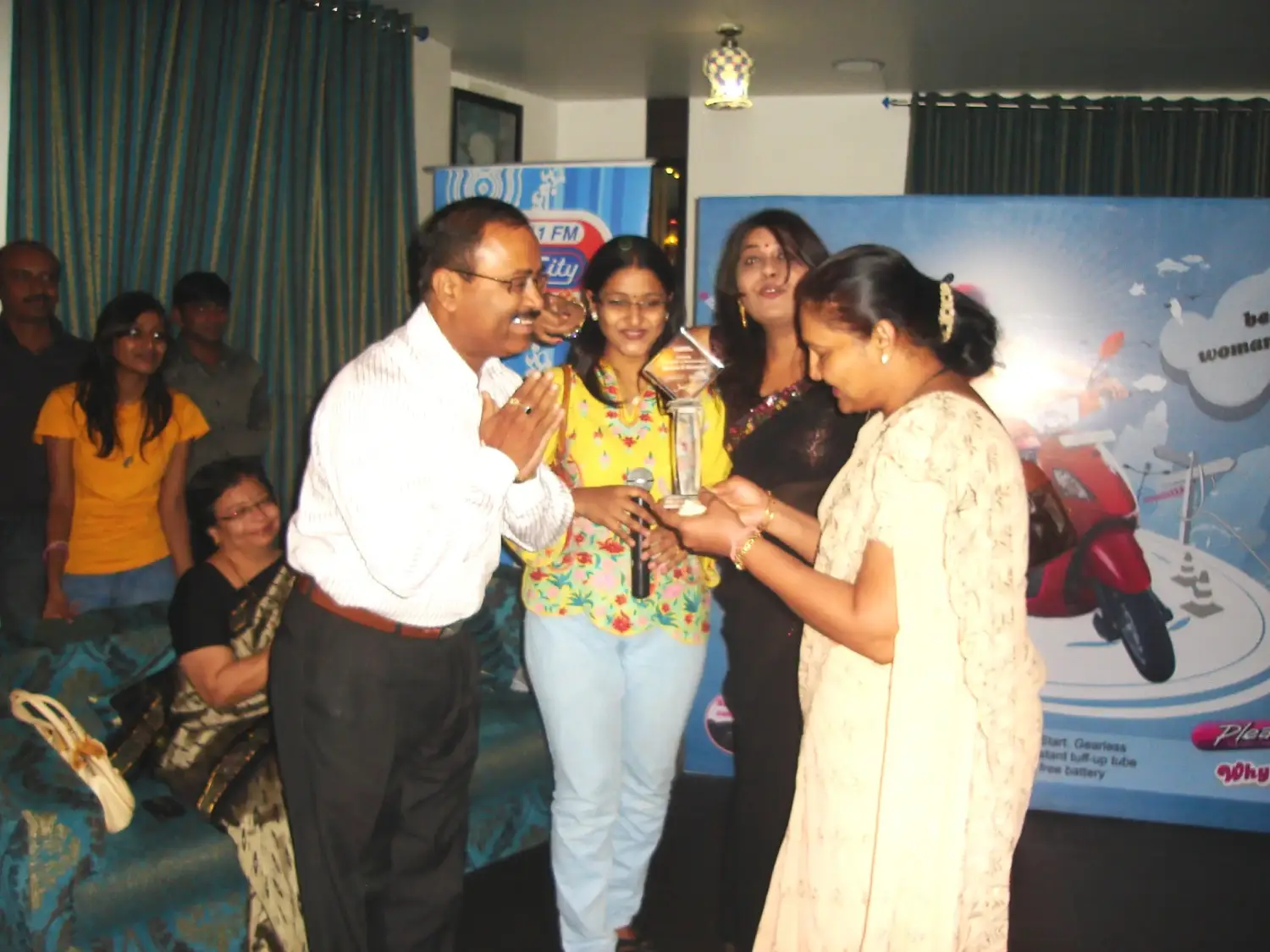 Balloon arch in orange, black, and white colors framing an ITT logo board lit with warm lights